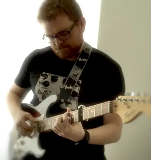 Photo of lead guitarist Matthew O'Rourke with a guitar in hand.